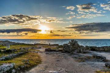 Sunset over the sea in the ancient Chersonesos among the ruins and buildings