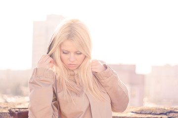 Outdoor portrait of young sensual woman in the hood closeup