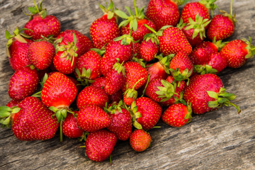 Ripe fresh strawberries on rustic wooden background. Top view