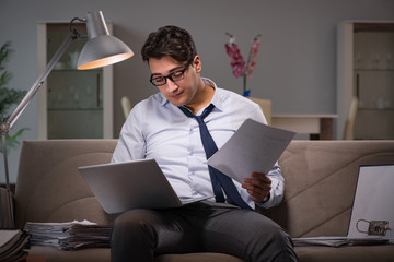 Businessman workaholic working late at home
