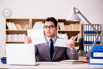 Businessman receiving letter envelope in office