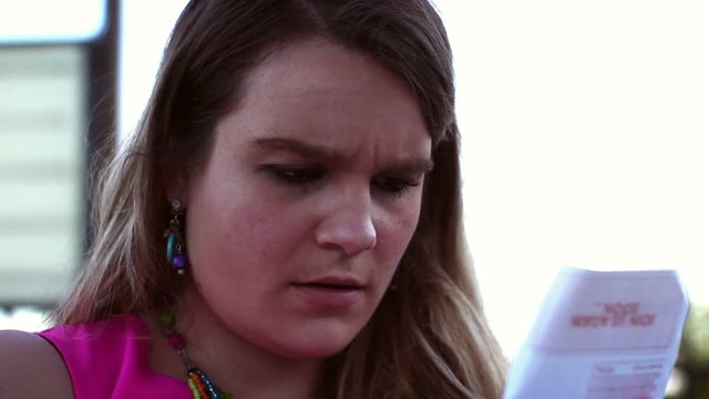 Hipster Millennial Woman is blown away by the cost of her restaurant bill