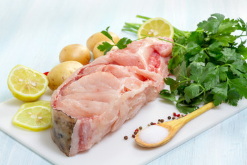 Raw Catfish with herbs and spices on table