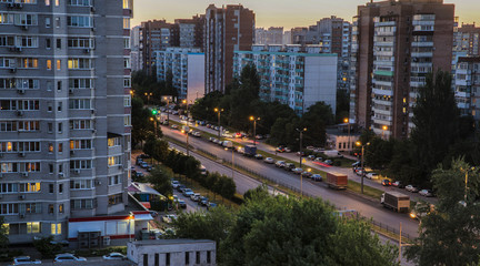 City at night with moon in the sky
