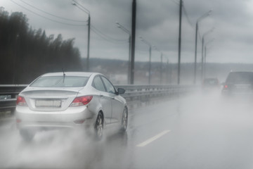 Fototapeta premium Traffic on highway on a foggy rainy day
