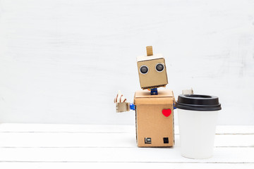 Robot with a heart drinks coffee and eats candy