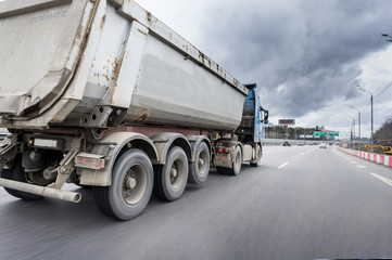 A lorry with tipping trailer in motion on the motorway