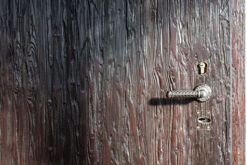 Vintage wooden door with iron handle and lock