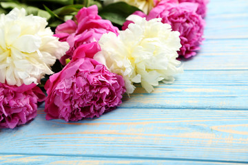 Bouquet of peony flowers on wooden table