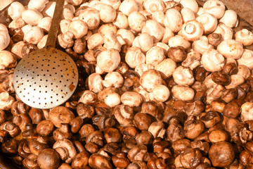 Fresh raw mushrooms in a iron pan