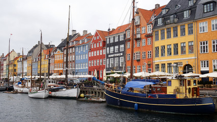 Fototapeta na wymiar COPENHAGEN, DENMARK - MAY 31, 2017: The Nyhavn canal. Nyhavn is waterfront, canal and entertainment district in Copenhagen. It is lined by brightly coloured bars, cafes and restaurants, Denmark