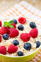 Oatmeal porridge with berries. Raspberries and blueberries.