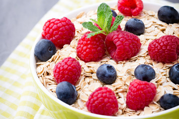 Oatmeal porridge with berries. Raspberries and blueberries.