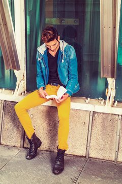 Young Man reading book outside in New York