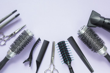 Hairdresser tools on lilac background with copy space