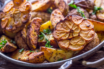 American potatoes. Baked potatoes in peel. Roasted potatoes with garlic spices salt cumin and herbs.