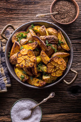 American potatoes. Baked potatoes in peel. Roasted potatoes with garlic spices salt cumin and herbs.