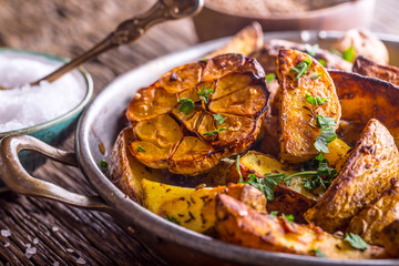 American potatoes. Baked potatoes in peel. Roasted potatoes with garlic spices salt cumin and herbs.