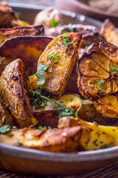 American potatoes. Baked potatoes in peel. Roasted potatoes with garlic spices salt cumin and herbs.