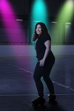 Woman Having Fun At Roller Skating Rink