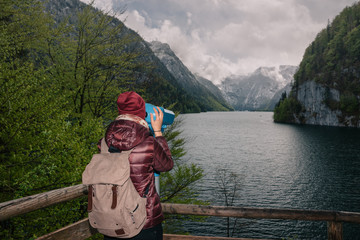 Germany. Berchtesgaden National. Girl with a backpack on the observation deck with a view of the lake Konigssee