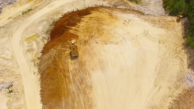 Aerial view of truck on muddy road on a construction site. Heavy industry from above. Industrial background from devastated landscape. 