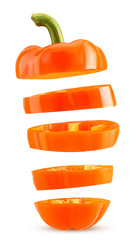 Slices orange bell pepper flying in the air