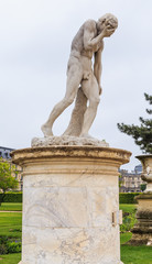 Fototapeta na wymiar Cain, who killed his brother Abel. Sculpture in the park of the Tuileries.Paris, France