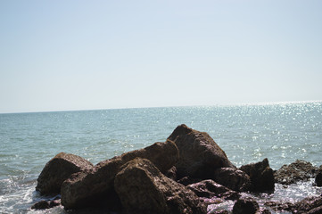 Sunny panoramic view of the ocean with rocks, seascape natural outdoors background