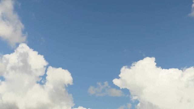 Low clouds are floating on blue sky. Time-lapse recording. 4K, Ultra HD, UHD