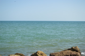 Sunny panoramic view of the ocean with rocks, seascape natural outdoors background