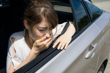 young woman getting carsickness. - obrazy, fototapety, plakaty