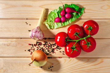 radish, tomatoes, onions, greens, garlic herb and spices on wooden background. Set for healthy foods. Ingredients for salad
