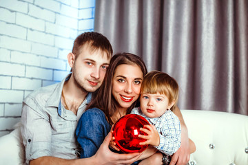 a family with a child sitting on the couch