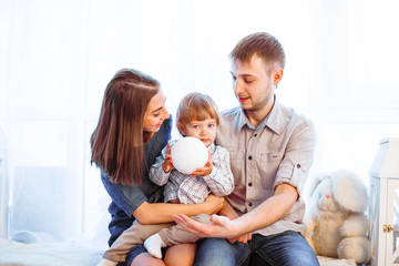 a family with a child sitting on the couch