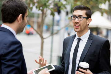 Fototapeta premium Two businessmen talking outdoors