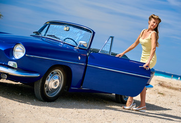 Woman near retro car on the beach
