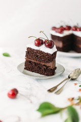 Chocolate cake with cherries on white marble background. Sugar free, lactose free concept