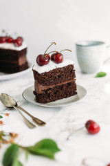 Chocolate cake with cherries on white marble background. Sugar free, lactose free concept