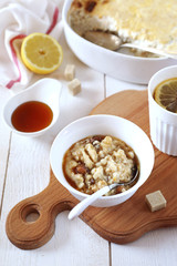 Oatmeal pudding with raisins and cinnamon, maple syrup dressing