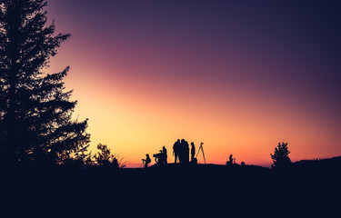 Silhouettes of unidentified photographers on the mountain peak in the morning