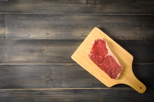 Raw Beef Striploin Steak On Cutting Board