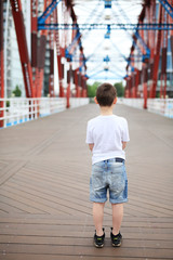Lonley boy standing on the bridge.