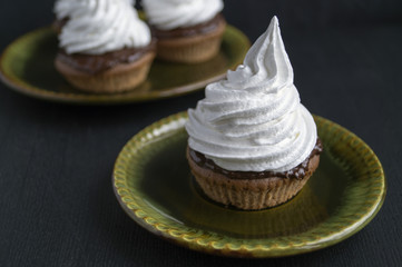 Sponge cake with cream, on a black background.