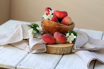 Ripe peaches in a wooden bowl