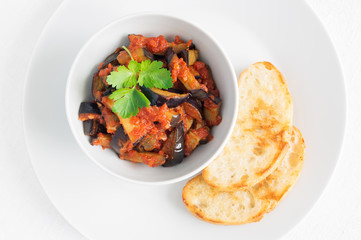 fried toasts and eggplant appetizer decorated with parsley