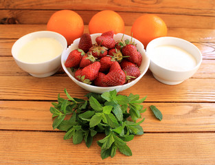 Ingredients for orange strawberry cold soup with cream and mint