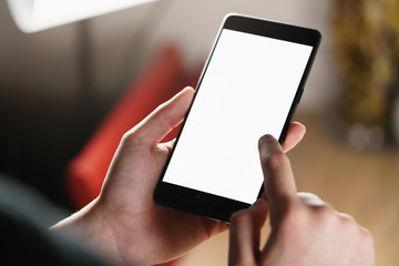 female teen hand using smartphone with blank white screen, shallow focus