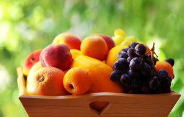 ripe fruits on wooden basket