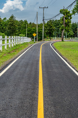 Fototapeta na wymiar Asphalt road with yellow line